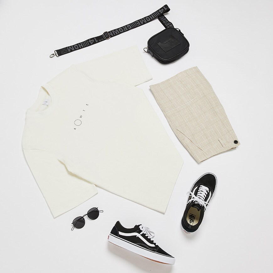 A picture of a flat lay outfit including a T-shirt by ASOS WHITE, Vans Old Skool trainers, sunglasses and a cross-body bag. Available at ASOS.