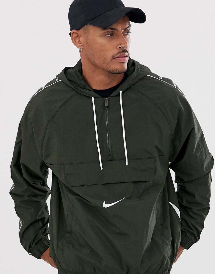 A picture of  a model wearing a Nike windbreaker jacket. Available at ASOS.