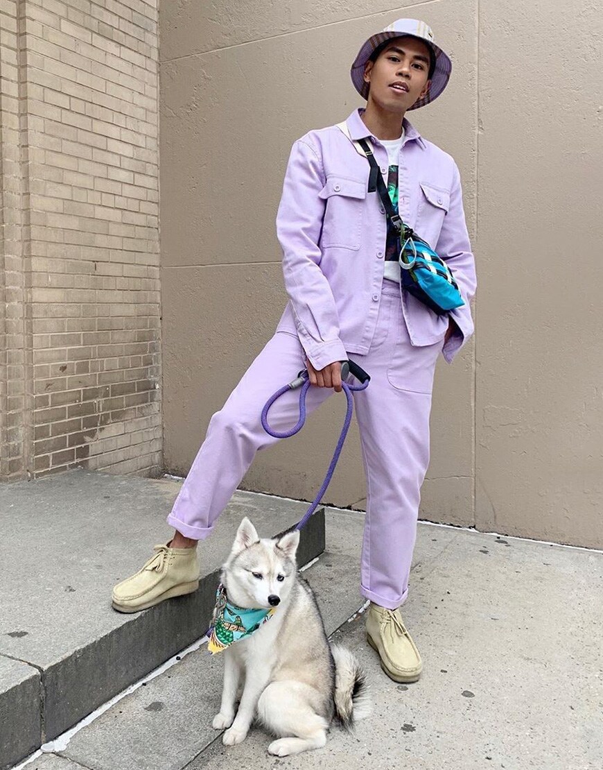 A picture of a man wearing a pastel utility co-ord and bucket hat