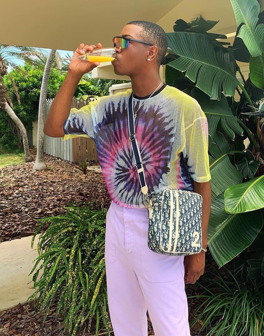 A picture of a man wearing a tie-dye T-shirt and cargo trousers.