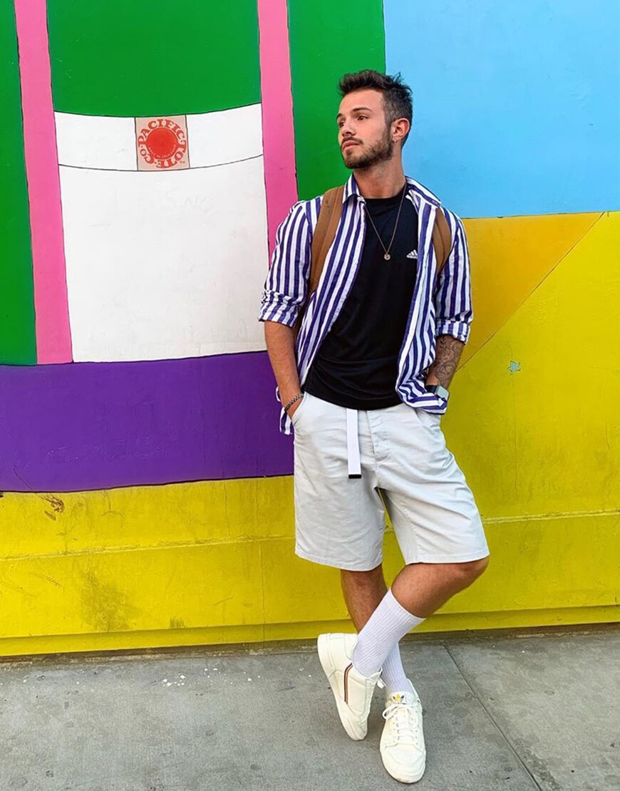 A picture of an ASOS Insider wearing a striped shirt, skater-style shorts and white trainers. Available at ASOS.