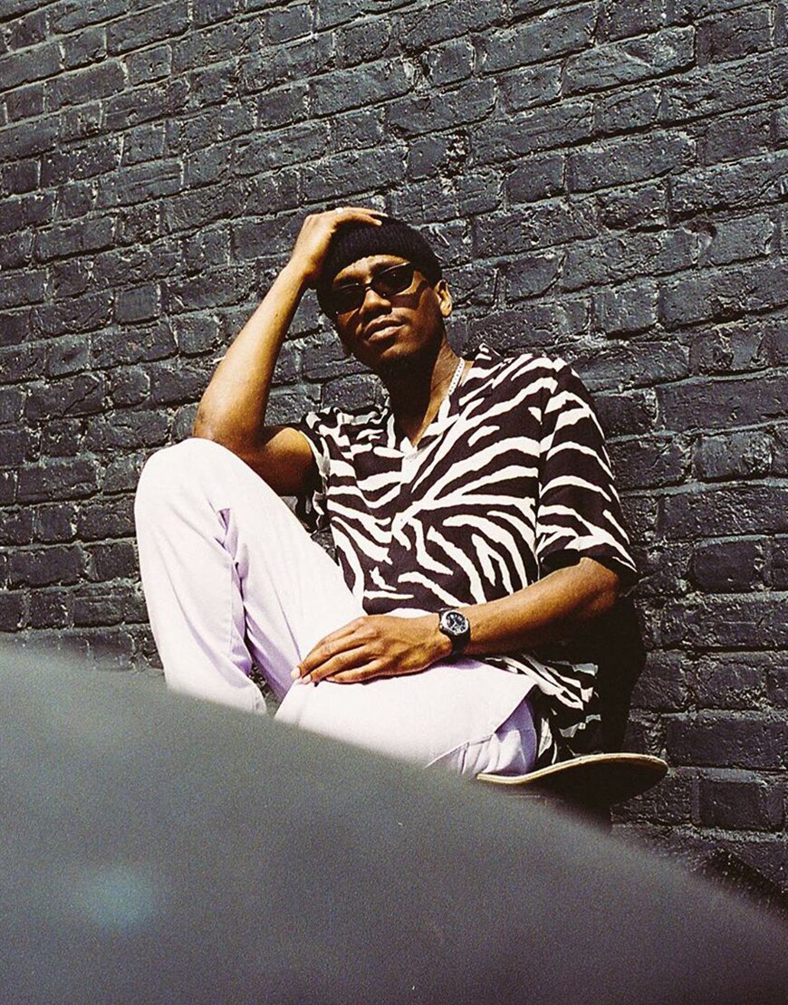 A picture of an ASOS Insider wearing a zebra-print shirt, sunglasses, a beanie and white chinos. Available at ASOS.