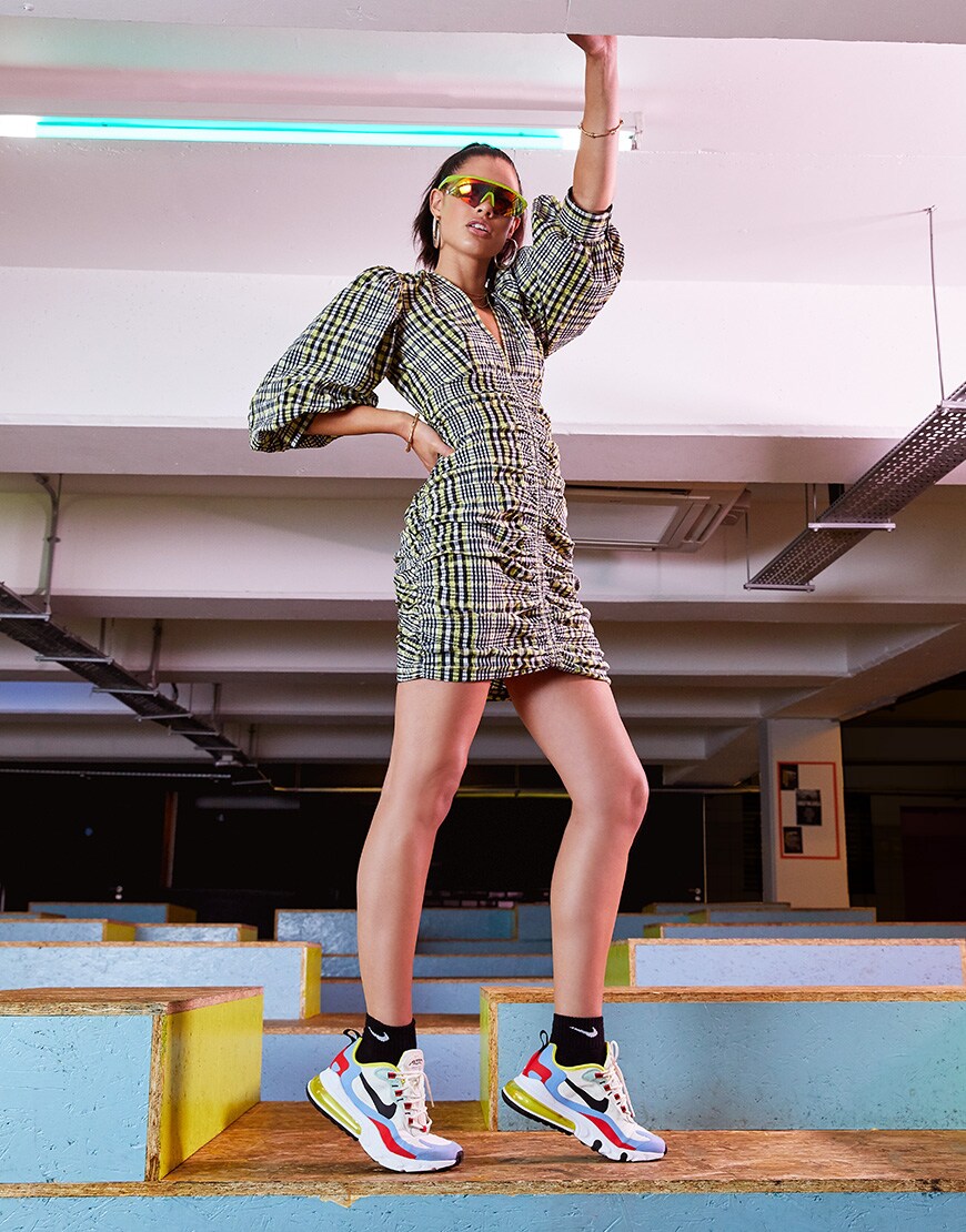 A picture of a model wearing the new Nike Air Max 270 React Bauhaus trainers. Available at ASOS.