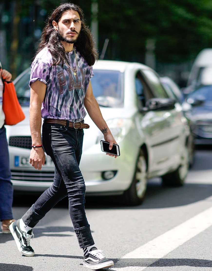 A picture of a street styler wearing a tie-dye T-shirt.