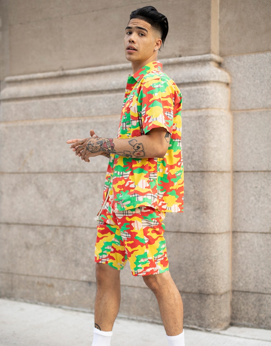 A picture of a man wearing a brightly coloured camo co-ord.