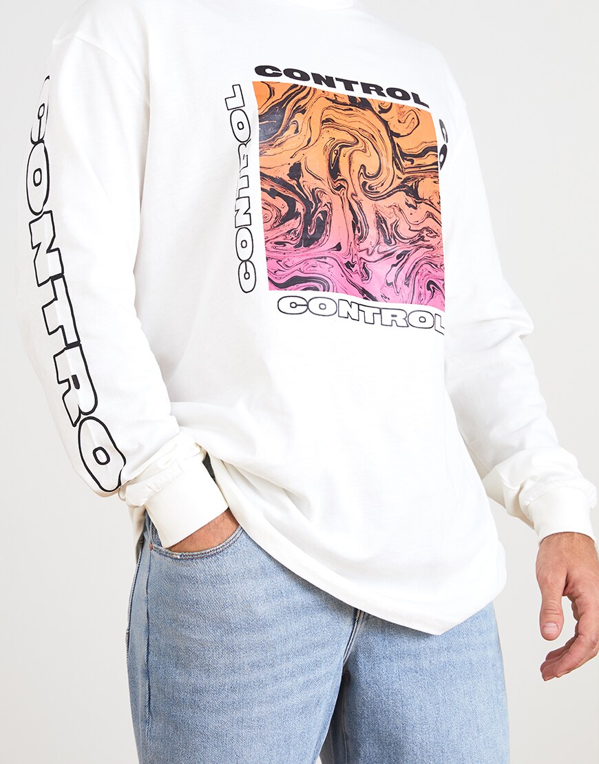 A picture of an ASOSer wearing a long-sleeve graphic T-shirt and ripped denim shorts. Available at ASOS.