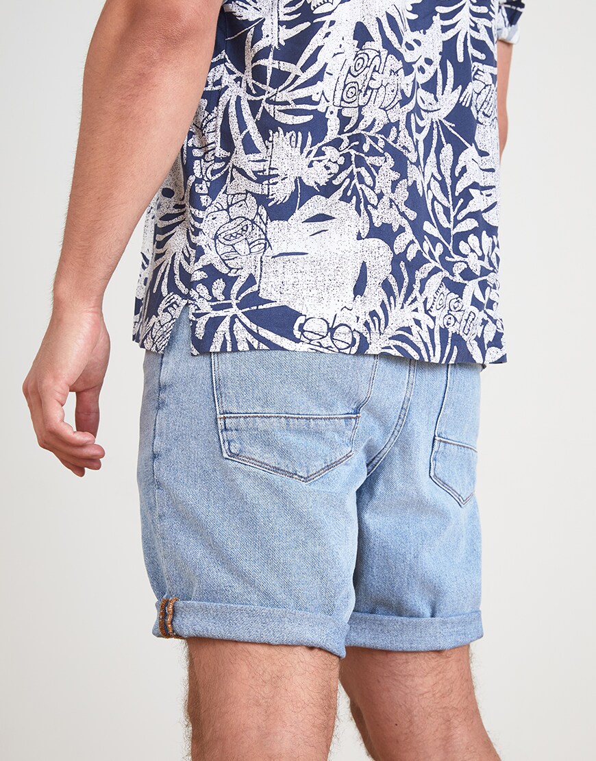 A picture of an ASOSer wearing a printed shirt and denim shorts. Available at ASOS.