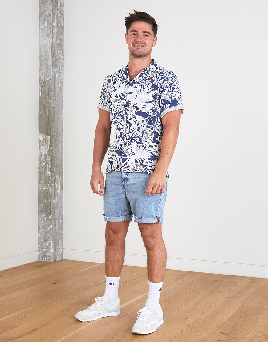 A picture of an ASOSer wearing a printed shirt and denim shorts. Available at ASOS.
