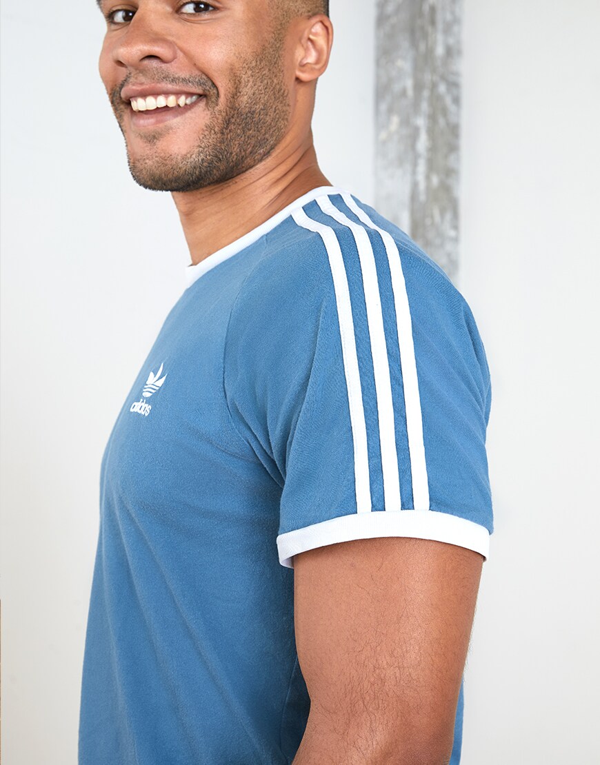 A picture of an ASOSer wearing an adidas T-shirt, chino shorts and Reebok trainers. Available at ASOS.