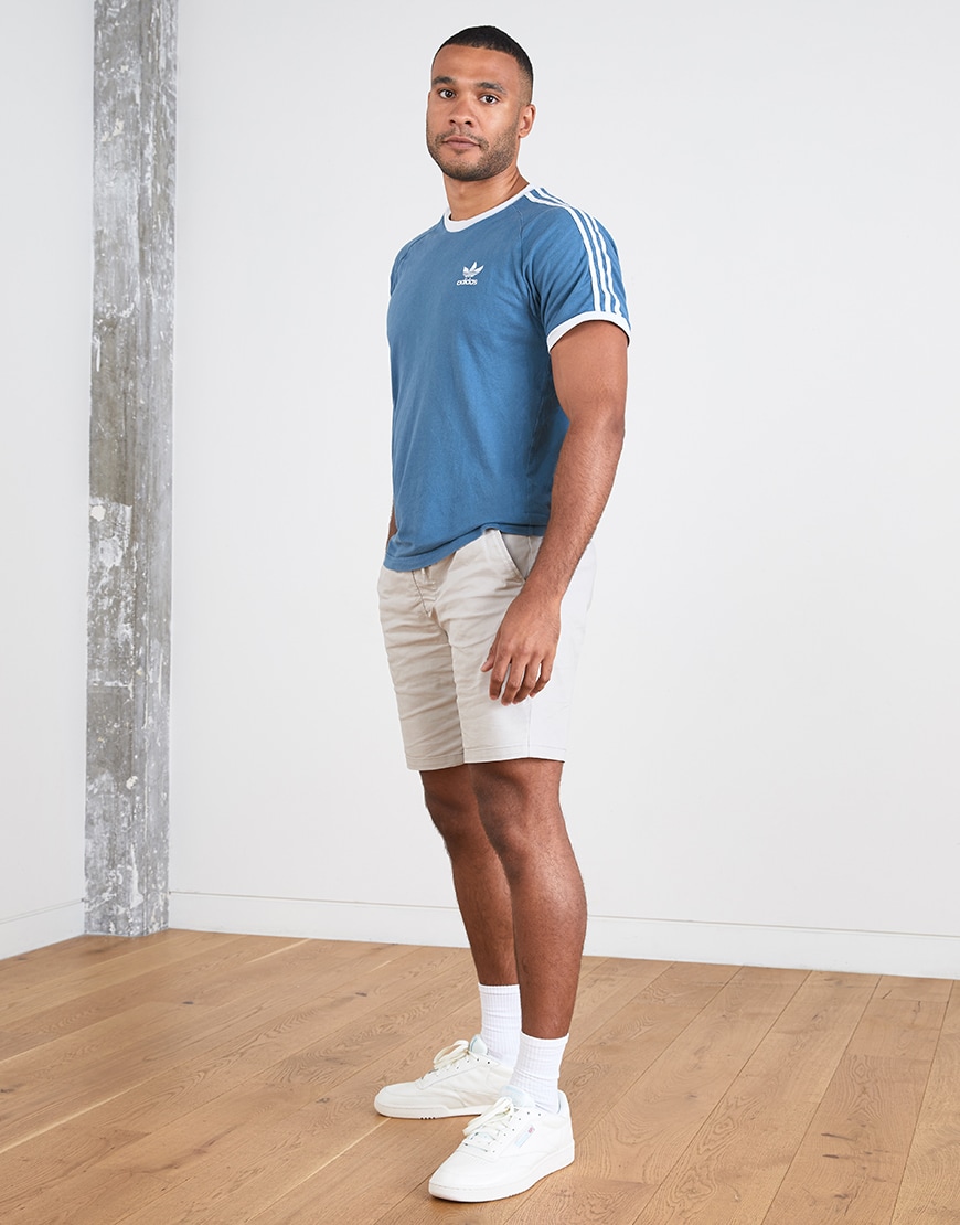 A picture of an ASOSer wearing an adidas T-shirt, chino shorts and Reebok trainers. Available at ASOS.