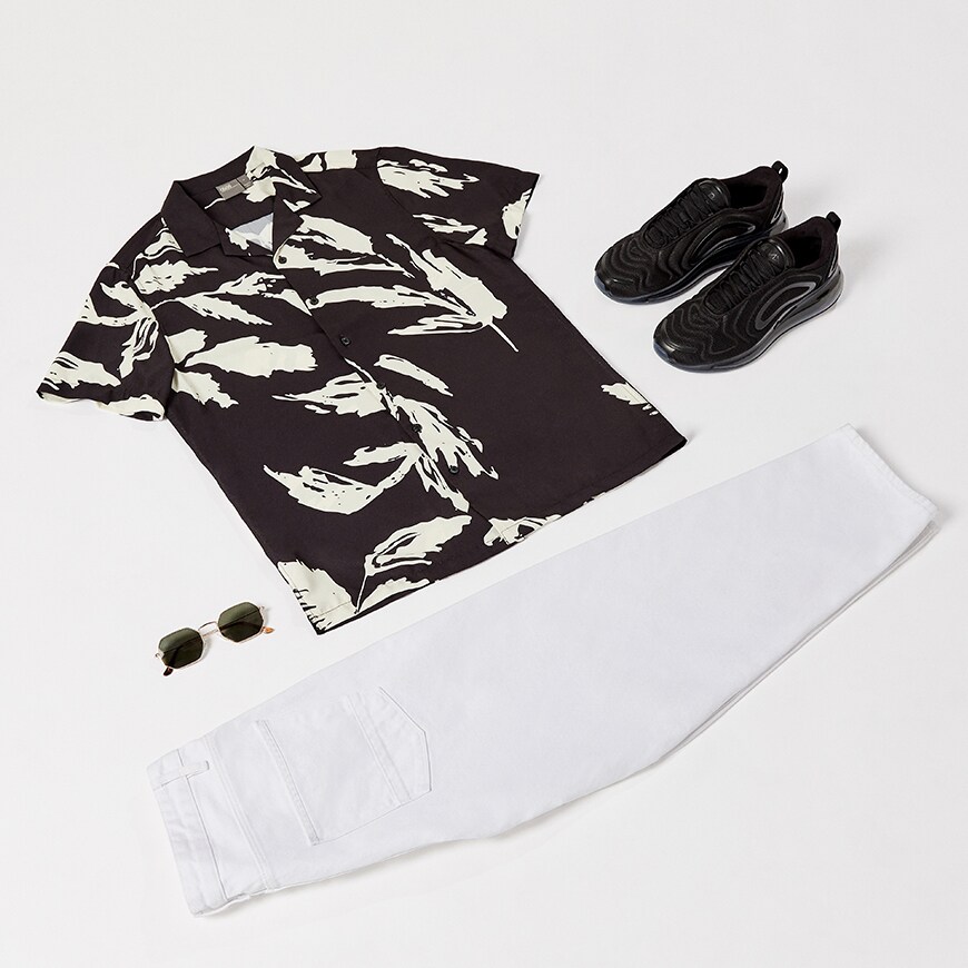 A flat-lay image including a black and white, revere-collar shirt, cropped white jeans and Nike 720 trainers. Available at ASOS.