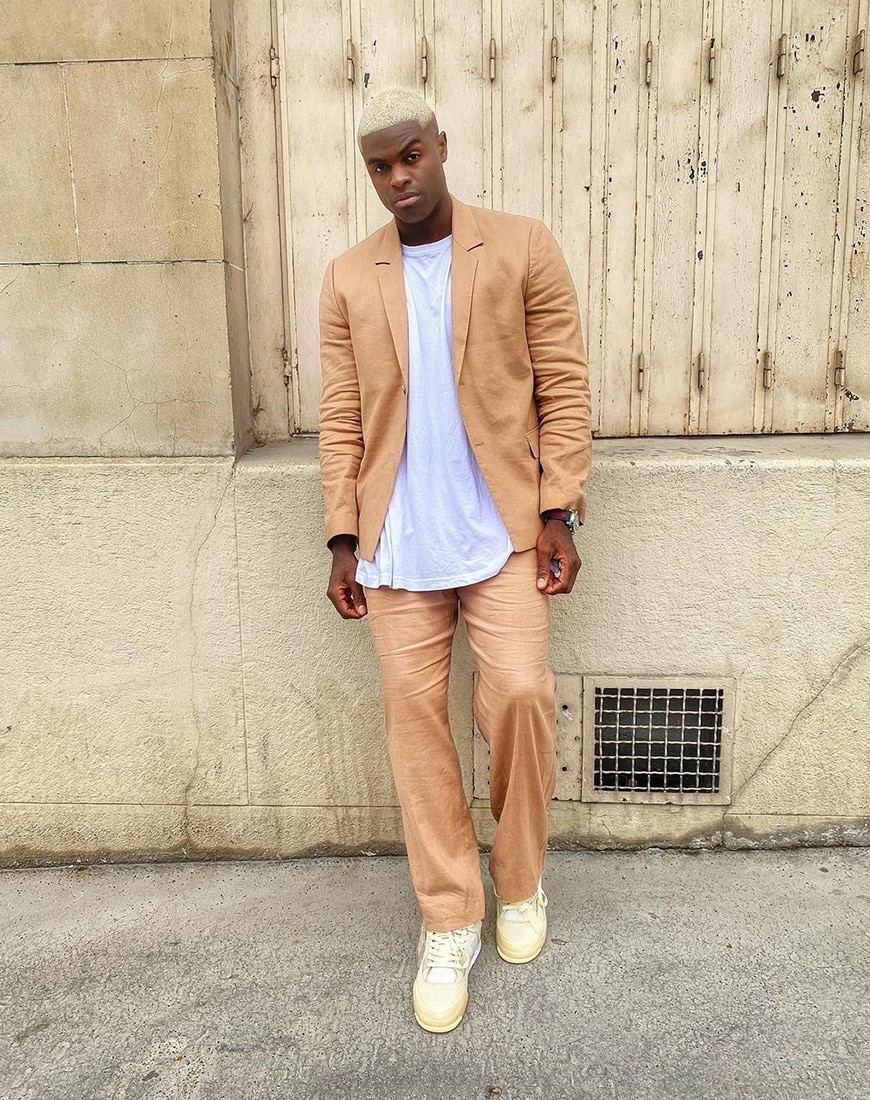 @iamalexandreossey wearing tan suit and white tee
