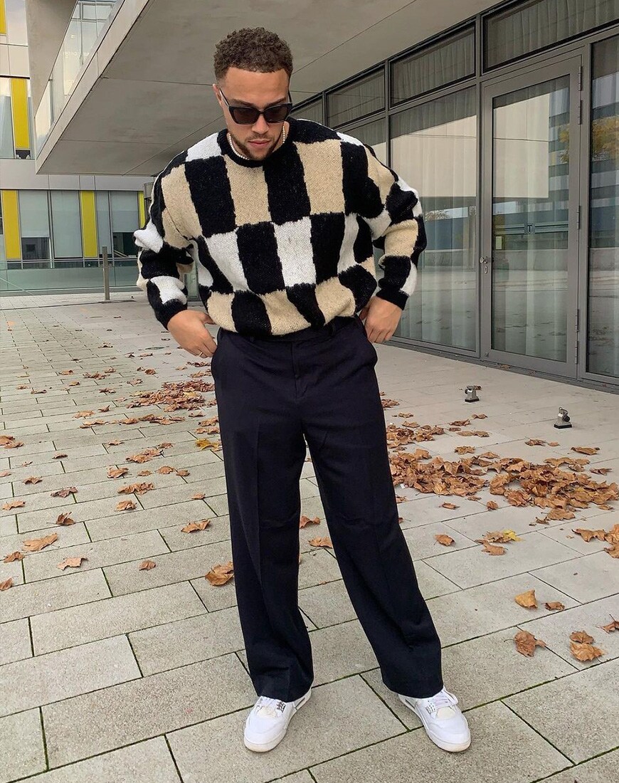 darrellxmontgomery wearing knitwear and trousers