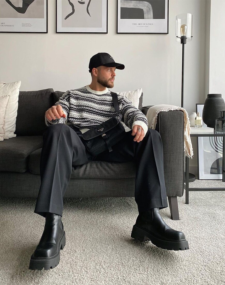 @reeceawalker wearing jumper, trousers and cap