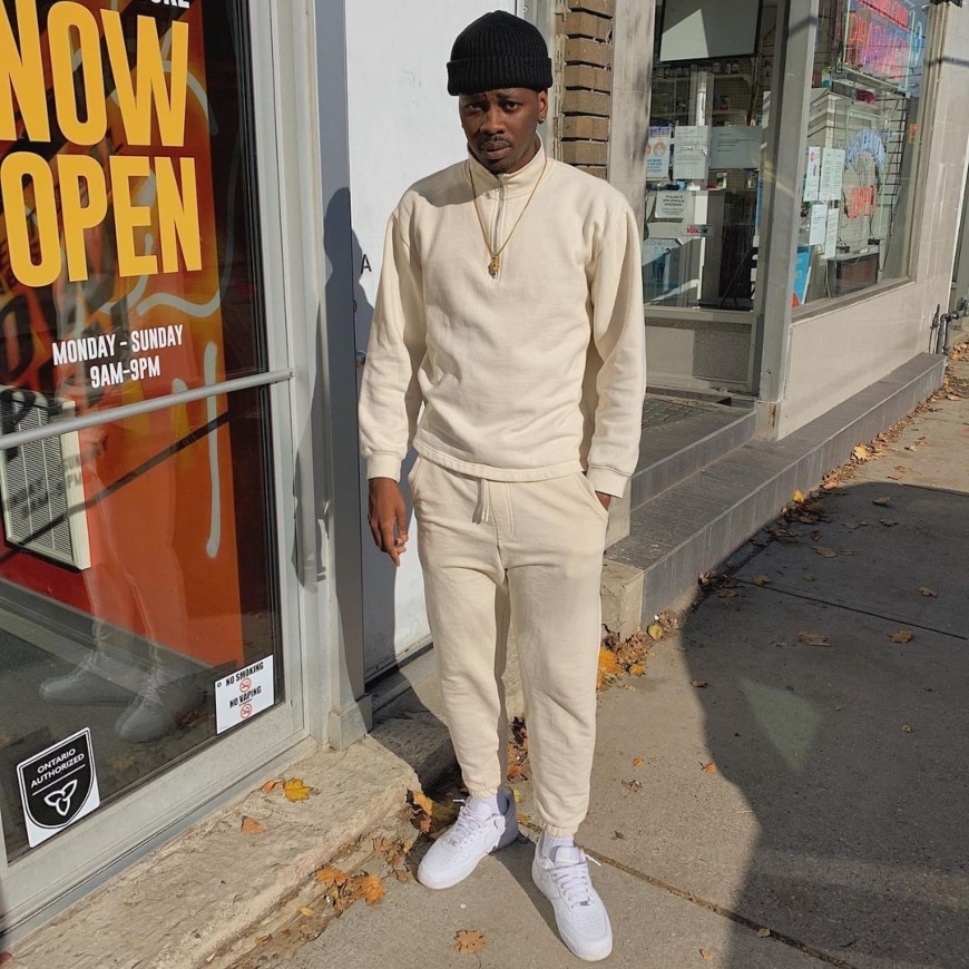 @888.romie wearing a cream sweatsuit with white Air Force 1s and a gold chain | ASOS Style Feed