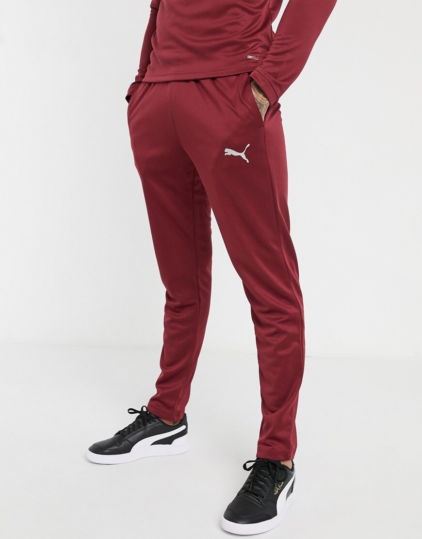 A picture of a model wearing panelled PUMA joggers