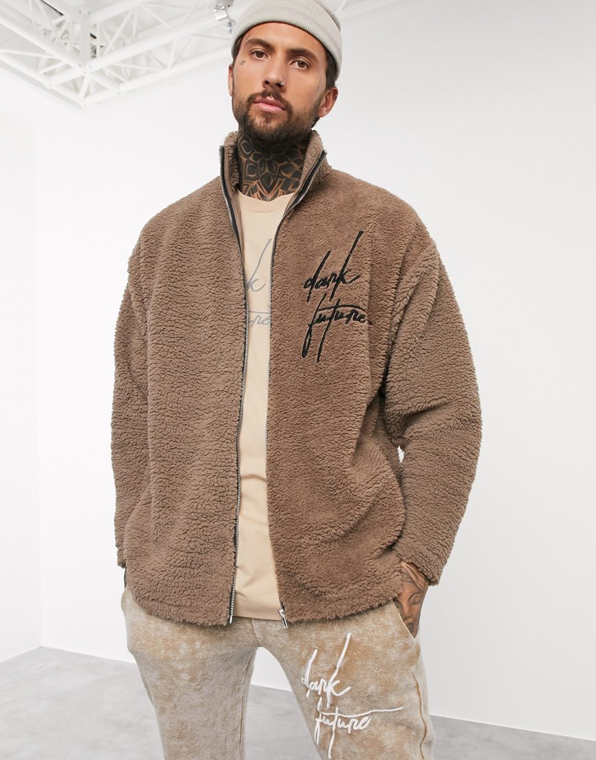 A picture of a model wearing a grey beanie and a brown borg jacket by Dark Future. Available at ASOS.