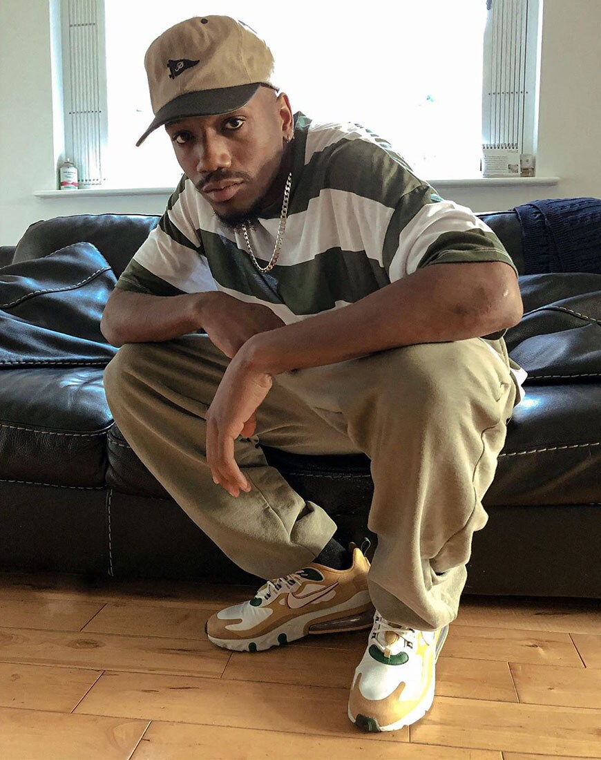 A picture of an ASOS Insider, asos_joshua wearing a cap, a striped T-shirt, relaxed joggers and Nike trainers. Available at ASOS.