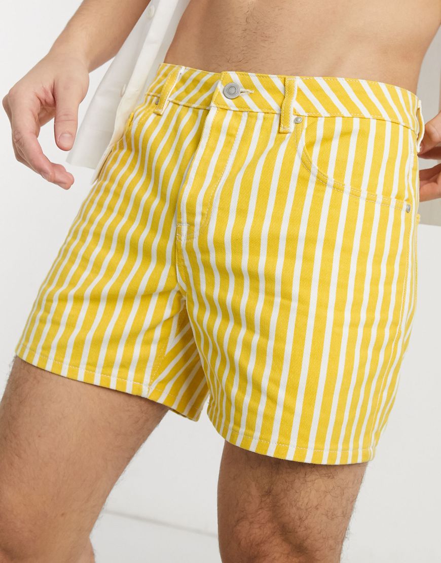 A picture of a model wearing a pair of yellow and white striped shorts. Part of the ASOS Responsible Edit, available now.