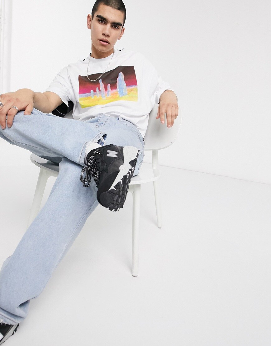 A picture of a model wearing a half-and-half design T-shirt by COLLUSION. Part of the Responsible Edit on ASOS. Available now.