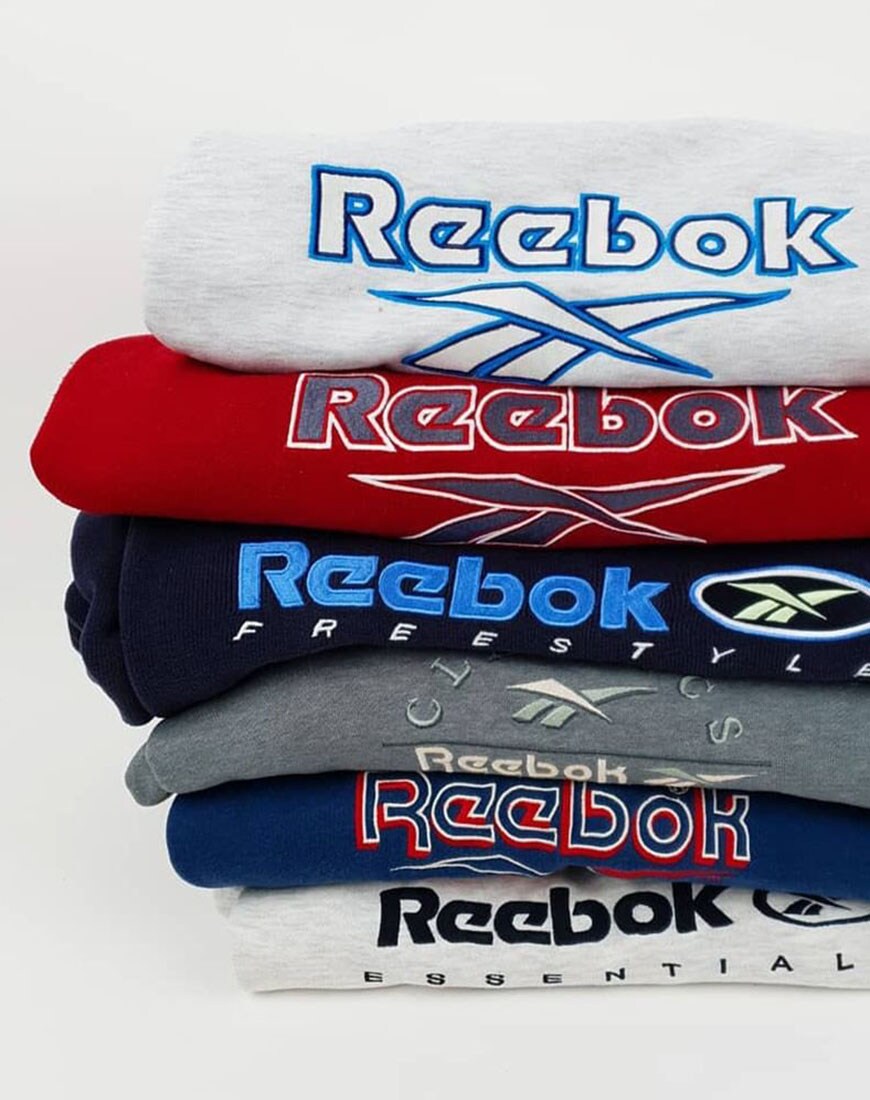 A picture of a stack of vintage Reebok sweatshirts in different colours. Available at ASOS Marketplace
