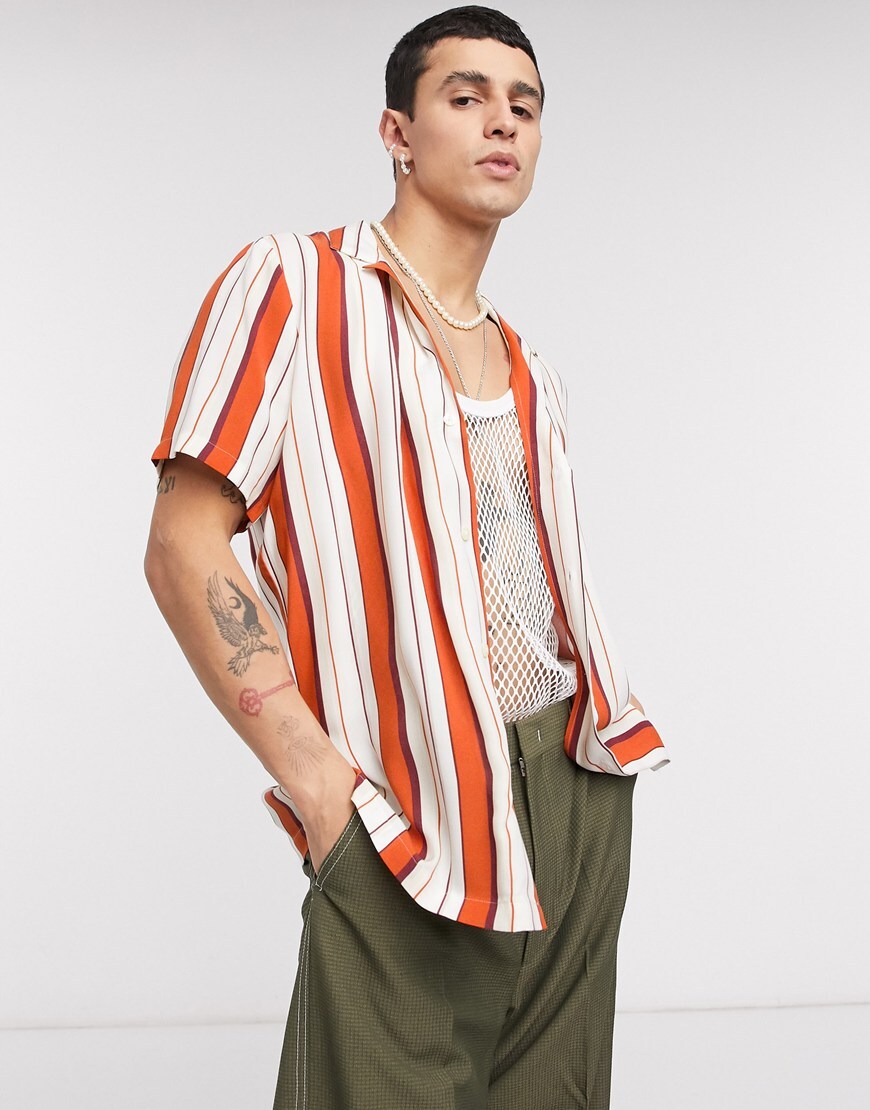 A picture of a model wearing a red and white striped shirt that's perfect for your staycation plans. Available at ASOS.