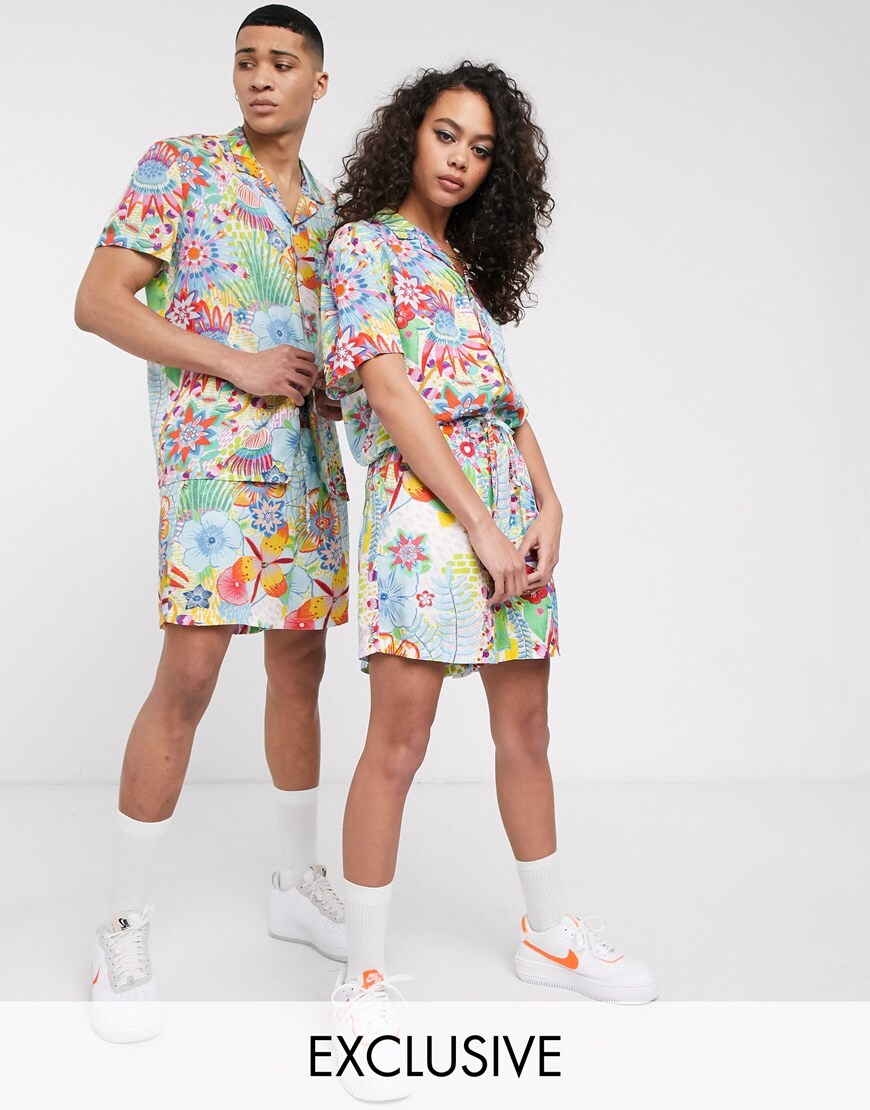 A picture of a male and female model both wearing a brightly coloured shirt and shorts co-ord from the brand-new Made In Kenya collection. Available now.