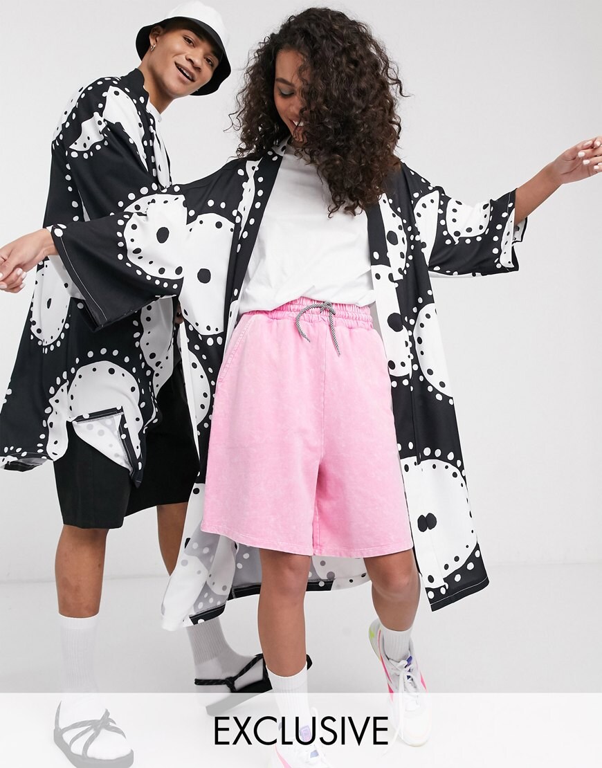 A picture of a male and female model wearing a black and white printed kimono from ASOS' brand-new Made In Kenya collection. Available now.