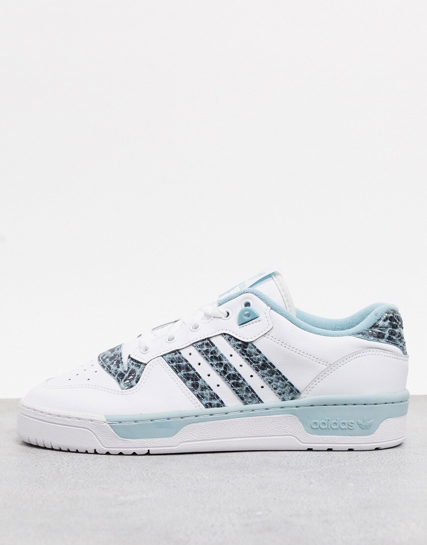 adidas Rivalry Low trainers in white and blue with snakeskin details. Wild. Available at ASOS.