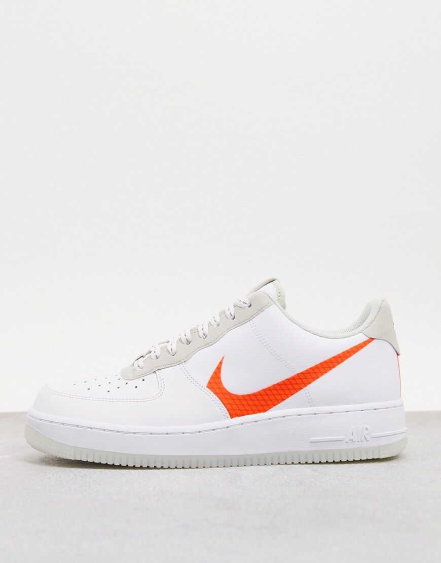 Nike Air Force 1 low sneakers featuring a bright-orange Swoosh in a white and beige colourway. Available at ASOS.