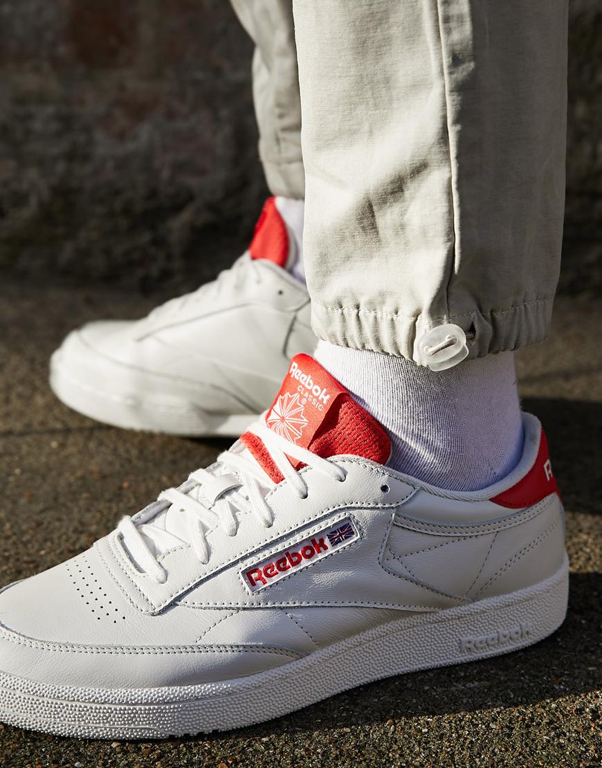 Reebok Classics Club C sneakers  in white with red highlights. Casual classics. Available at ASOS.
