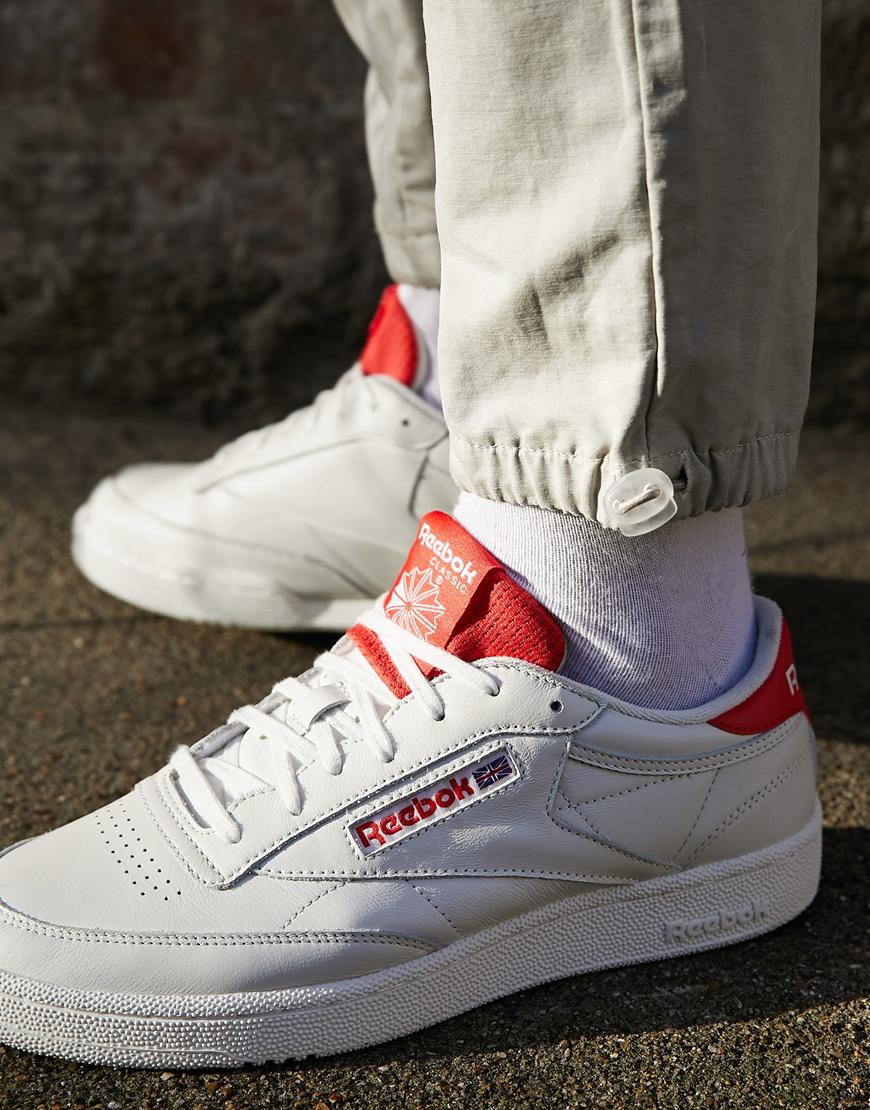 Reebok Classics Club C sneakers in white with red highlights. Casual classics. Available at ASOS.
