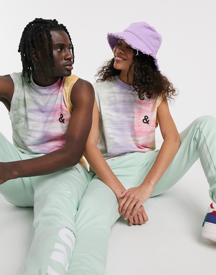 A picture of a male and female model both wearing a unisex sleeveless T-shirt from the new ASOS X GLAAD collection. Available now.