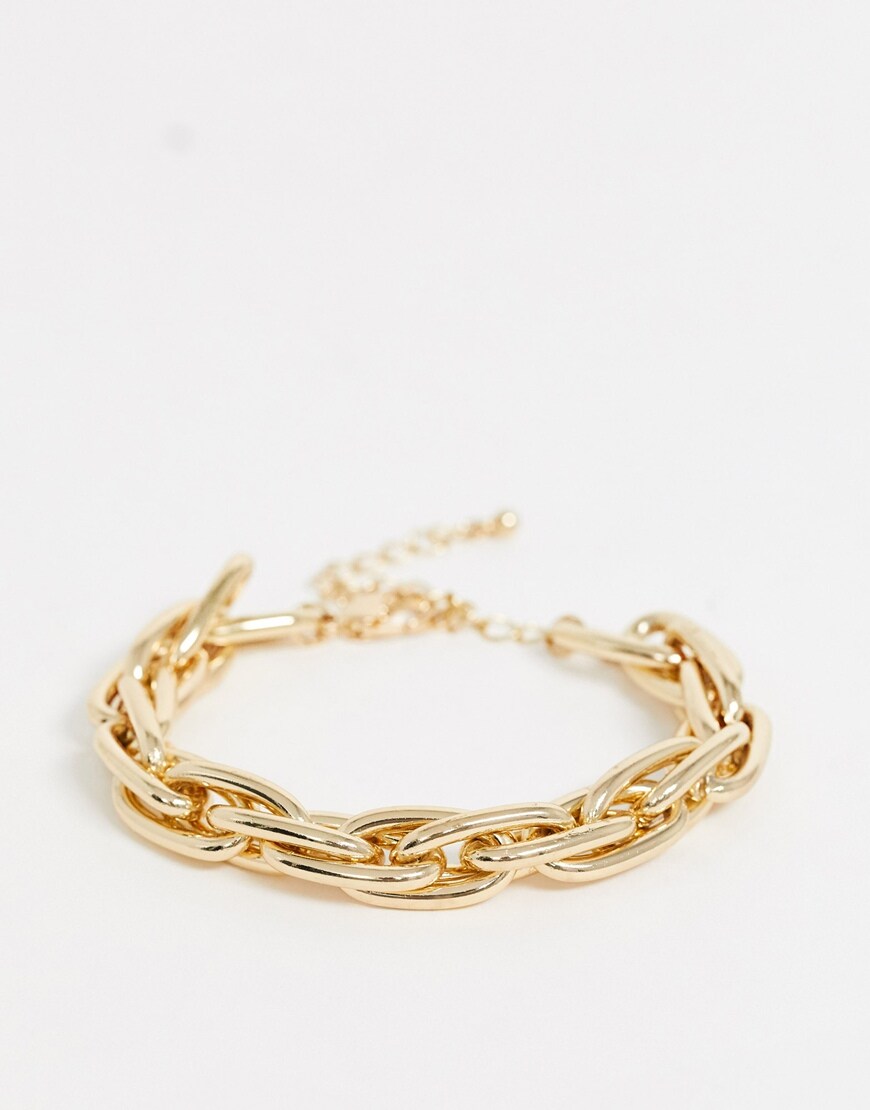 A picture of a gold-tone chunky bracelet by Uncommon Souls. It literally goes with everything. Available at ASOS.