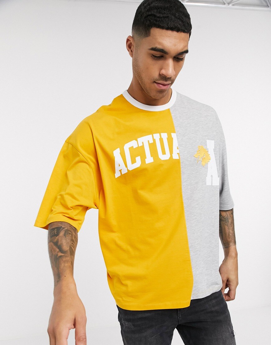 A picture of a man wearing a varsity t shirt in yellow and grey by ASOS DESIGN | ASOS STYLE FEED