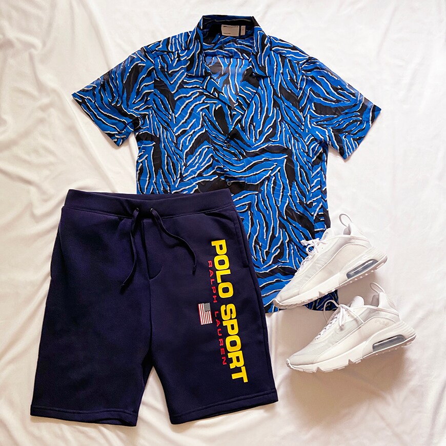 A picture of a date night outfit including a blue and black animal print shirt, jersey shorts by Polo Ralph Lauren and Nike trainers. Ideal for video calls or just staying comfy during dinner at your place. Available at ASOS.