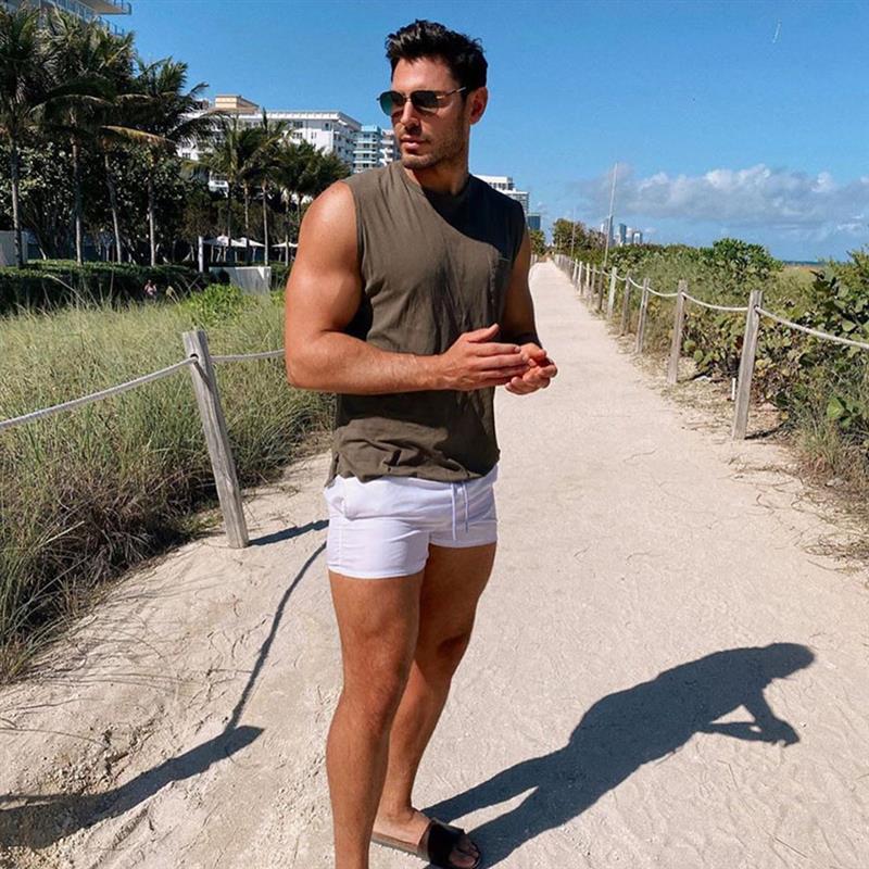 Joey Zauzig wearing white shorts and a sleeveless brown top | ASOS Style Feed