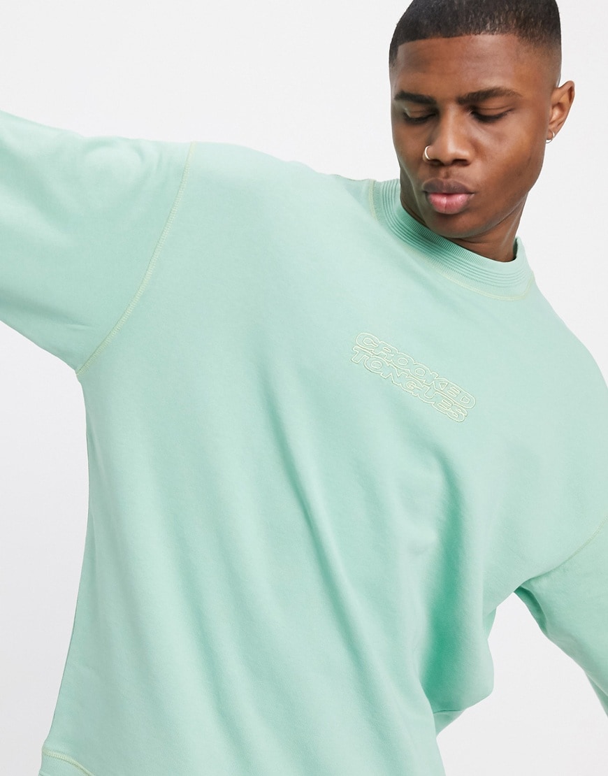 A picture of a model wearing a pastel green oversized sweatshirt by Crooked Tongues. Available at ASOS | ASOS Style Feed