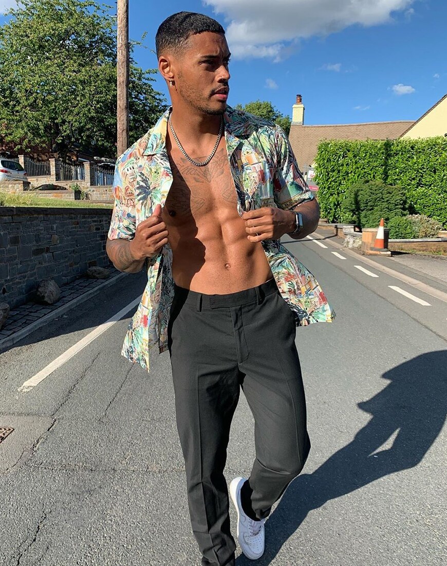 A picture of a man wearing a tropical print shirt with smart black trousers and Nike trainers. Available at ASOS | ASOS Style Feed