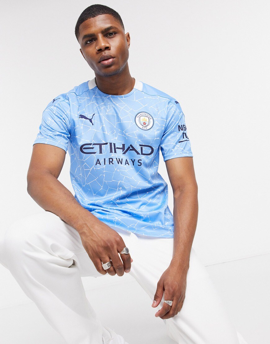 A picture of a model wearing Manchester City's 2020/21 home jersey, now available at ASOS | ASOS Style Feed