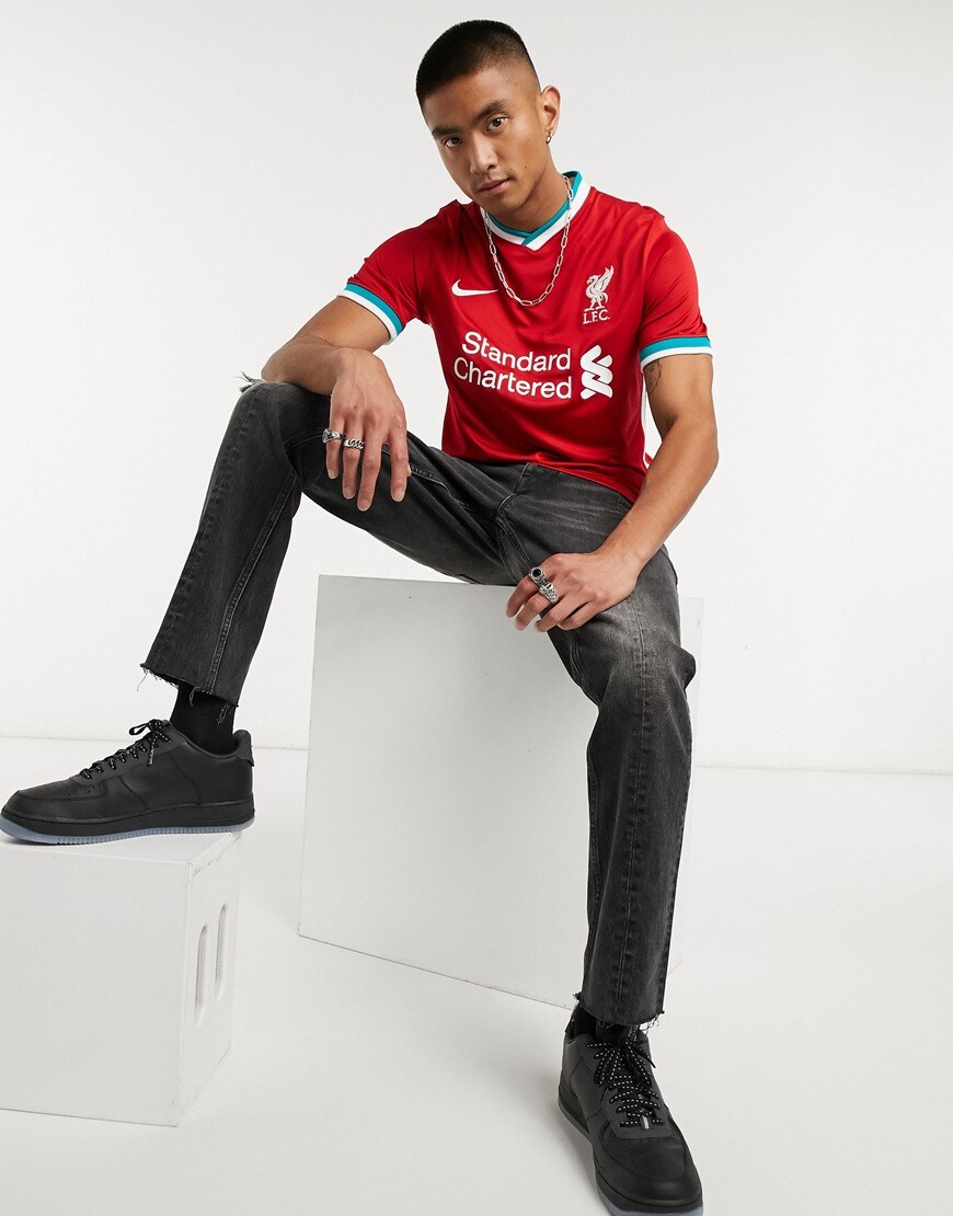 A picture of a model wearing Liverpool Football Club's 2020/21 home jersey, now available at ASOS | ASOS Style Feed