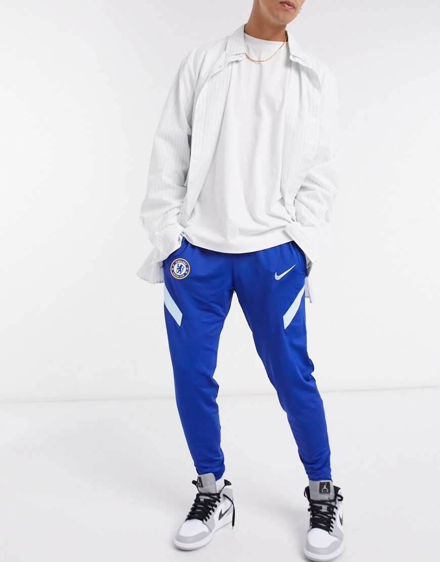 A picture of a model wearing Chelsea Football Clubs 2020/21 Strike joggers. Now available at ASOS | ASOS Style Feed