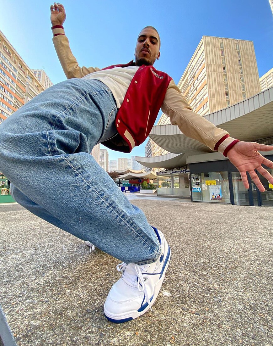 ASOS Ruddy wearing a varsity jacket, jeans and white sneakers | ASOS Style Feed