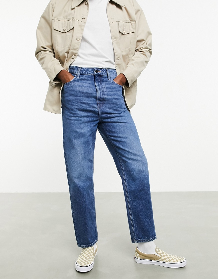 A picture of a man wearing a pair of high-waist jeans by ASOS DESIGN. Part of the new sustainable denim range. Available at ASOS | ASOS Style Feed