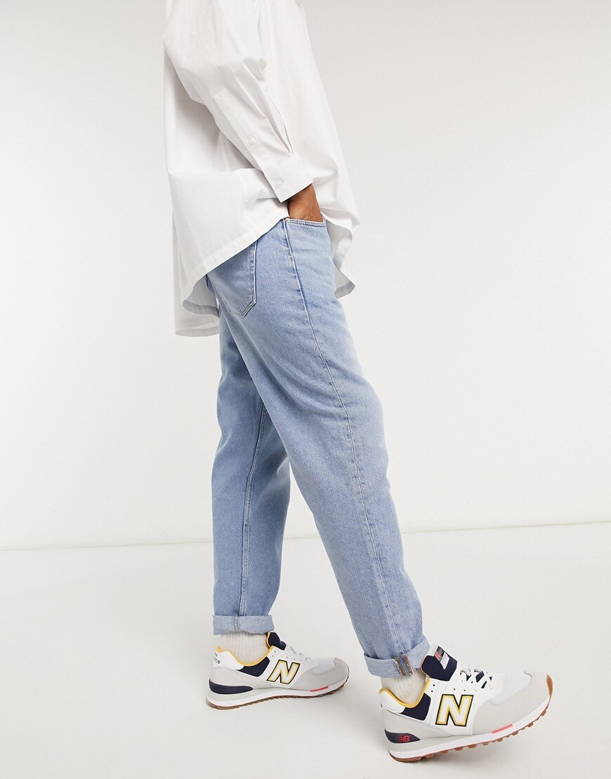 A picture of a model wearing a pair of light-wash blue, straight-crop jeans from the new ASOS DESIGN sustainable denim range | ASOS Style Feed