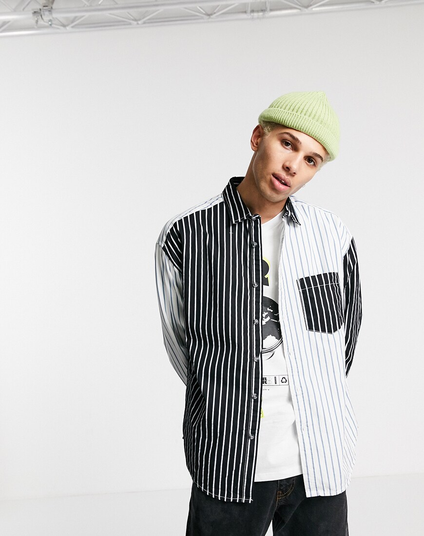 A picture of a male model wearing a unisex striped shirt made from upcycled material. Part of the new ASOS DESIGN Circular Collection.