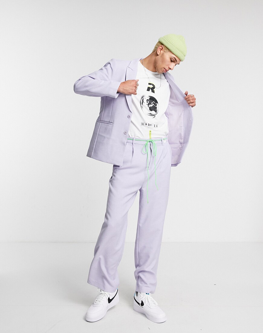 A picture of a male model wearing a unisex purple suit made entirely of recycled materials from the ASOS DESIGN Circular Collection. Available at ASOS | ASOS Style Feed