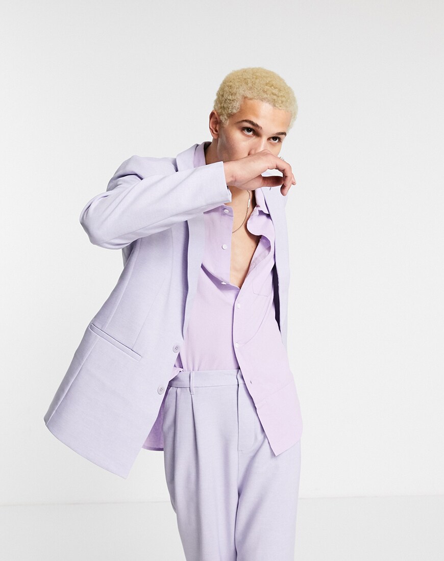 A picture of a male model wearing a unisex purple suit made entirely of recycled materials from the ASOS DESIGN Circular Collection. Available at ASOS | ASOS Style Feed
