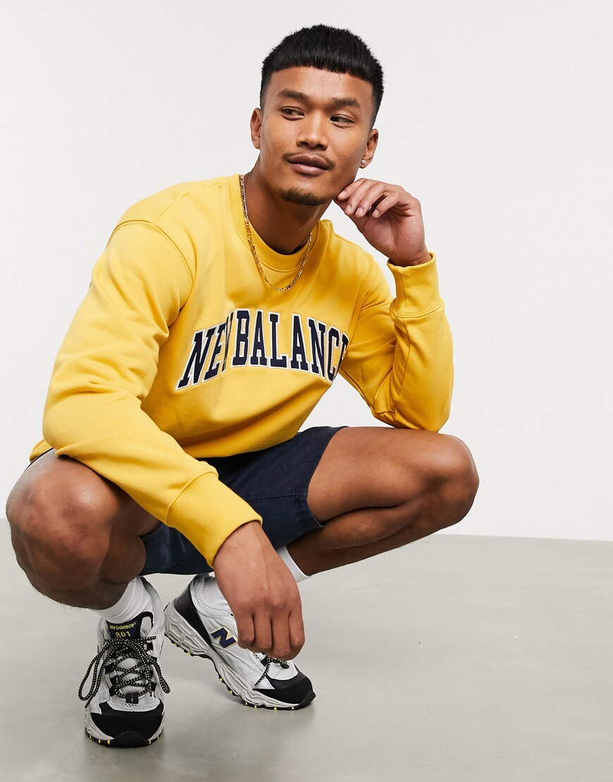 An image of a man wearing a yellow sweatshirt by New Balance | ASOS Style Feed