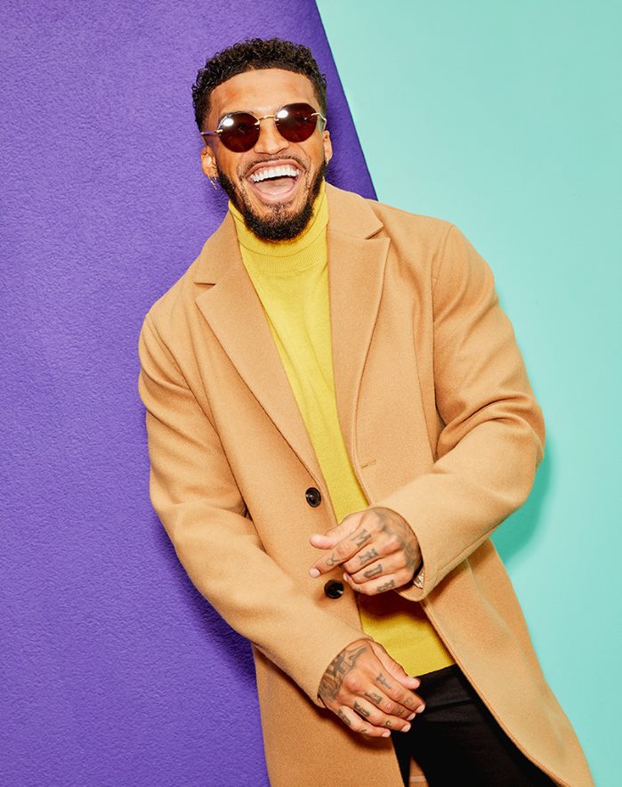 Michael Griffiths in mustard ASOS DESIGN roll neck jumper and camel overcoat